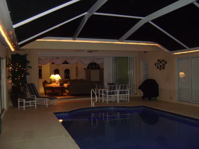 Swimming pool and sun terrace by night.