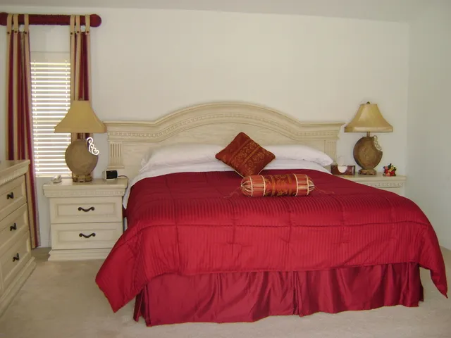 Master bedroom with ensuite facilities overlooking the pool and lake.