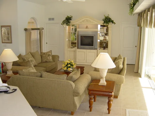 Living area looking out over swimming pool and lake.