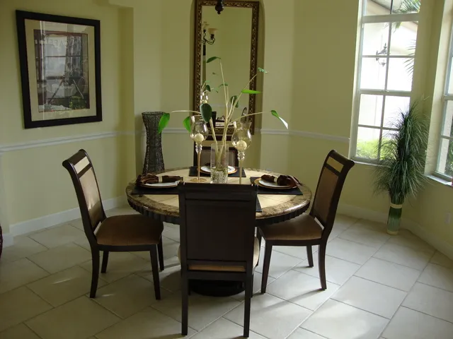 Opulent formal dining room with Travertine marble suite and vaulted ceiling